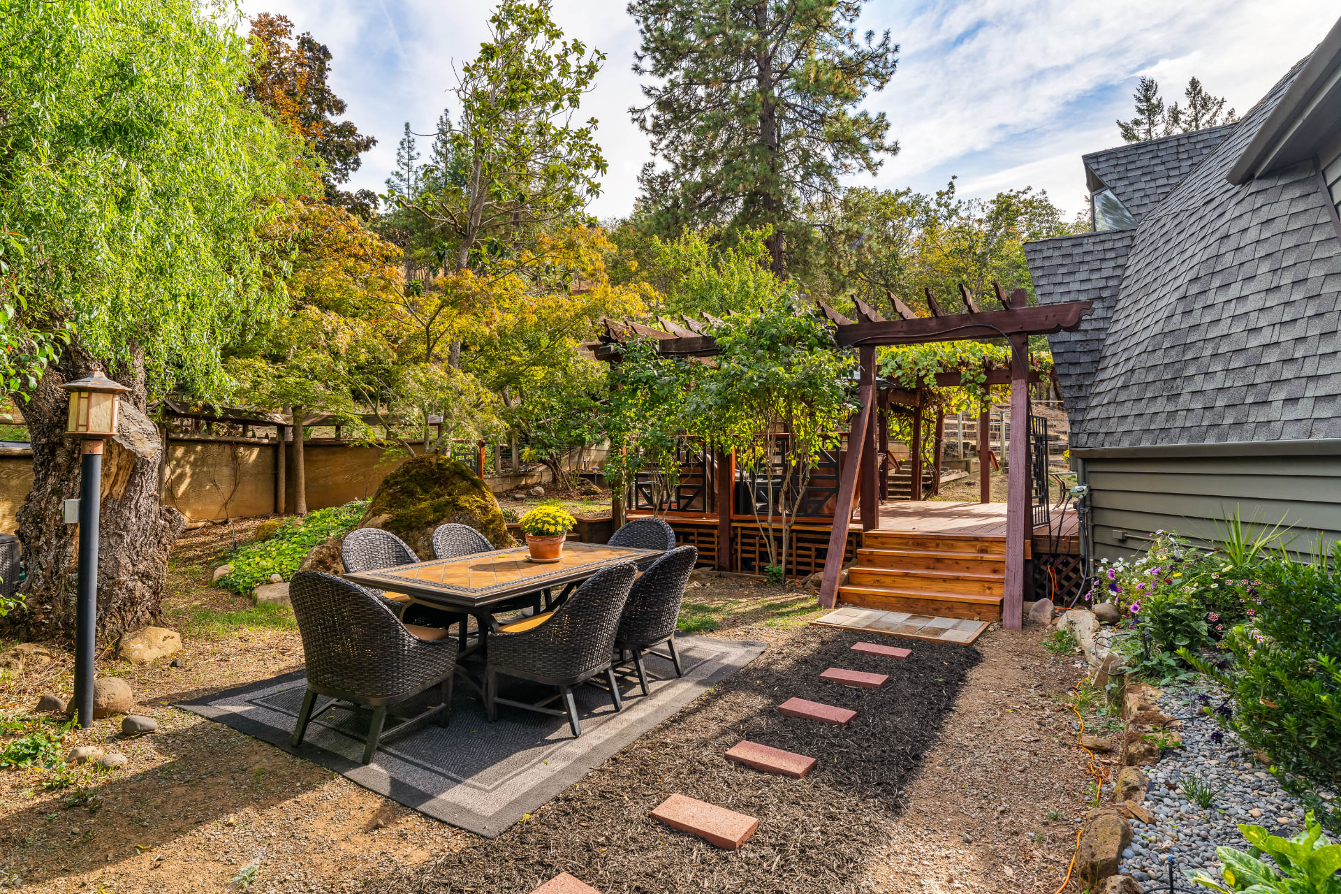 Garden dining area beside the home and vine-covered pergola