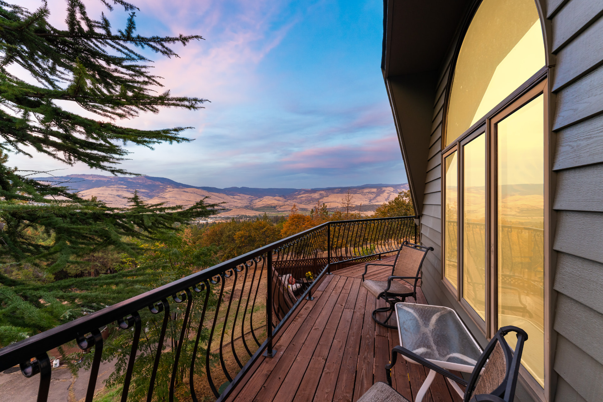 Wraparound deck and valley view beneath a twilight sky