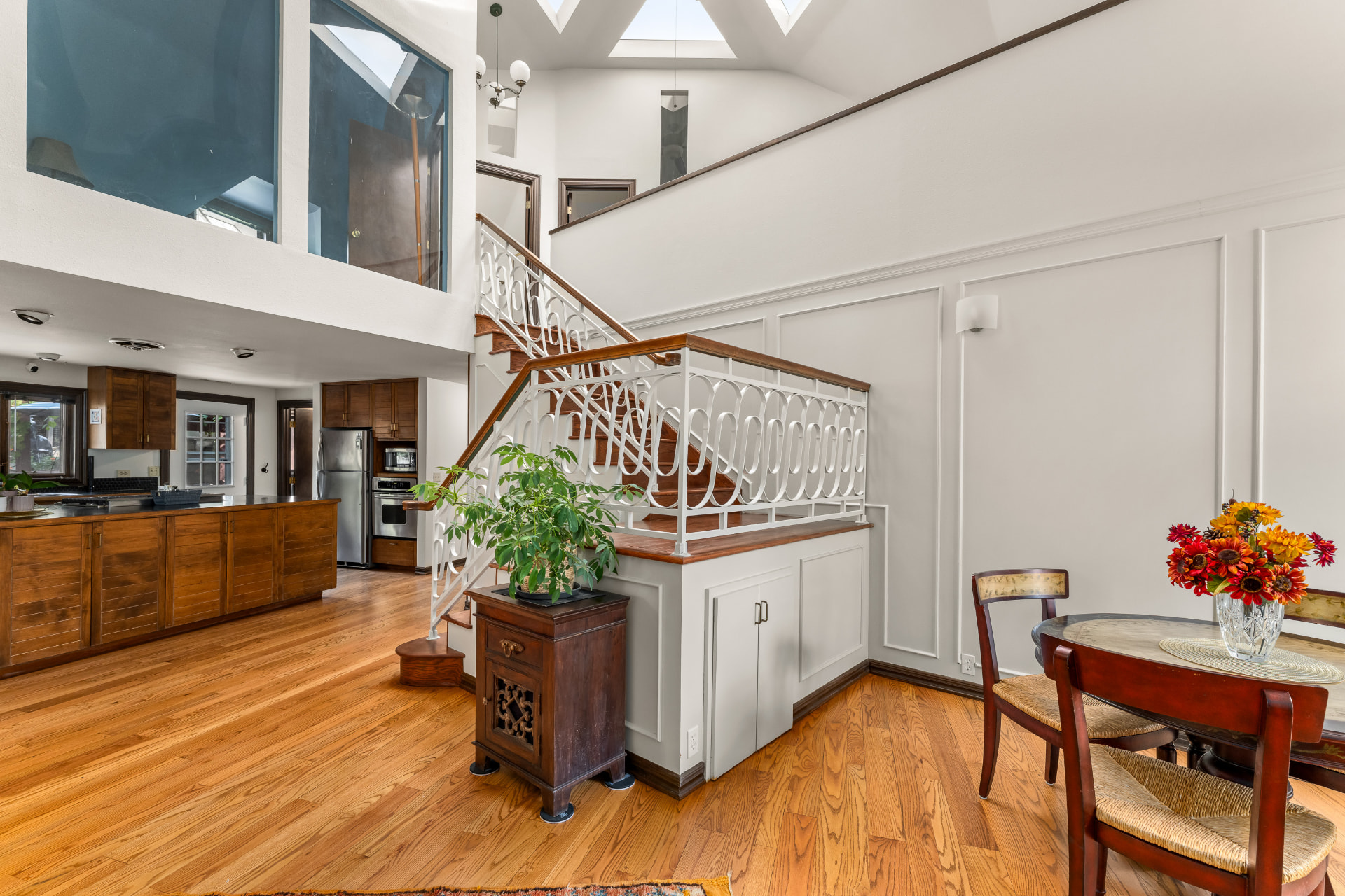 Main-level dining nook, staircase, skylights, and kitchen